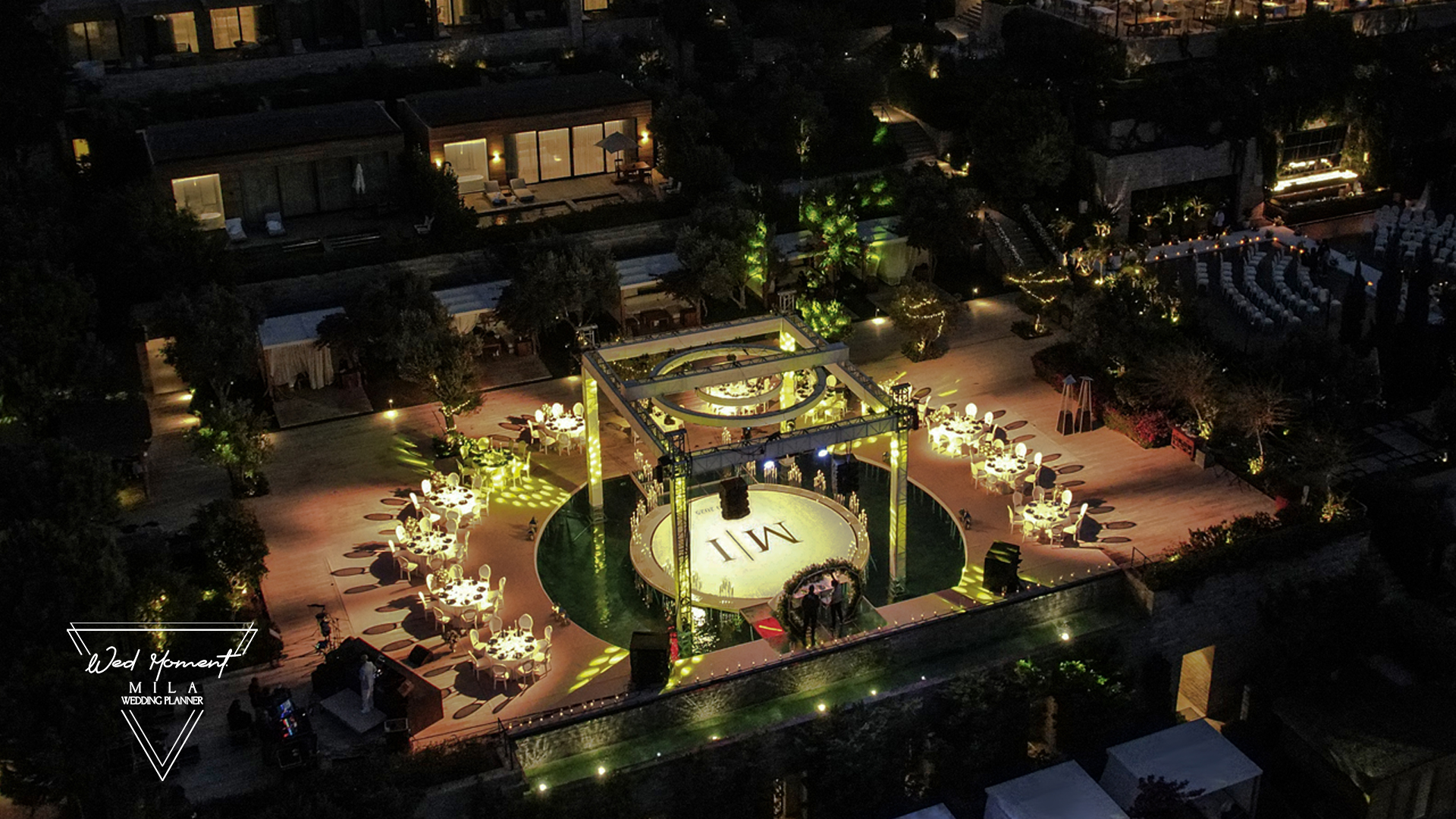 Beautifully decorated event space with tables and elegant lighting.